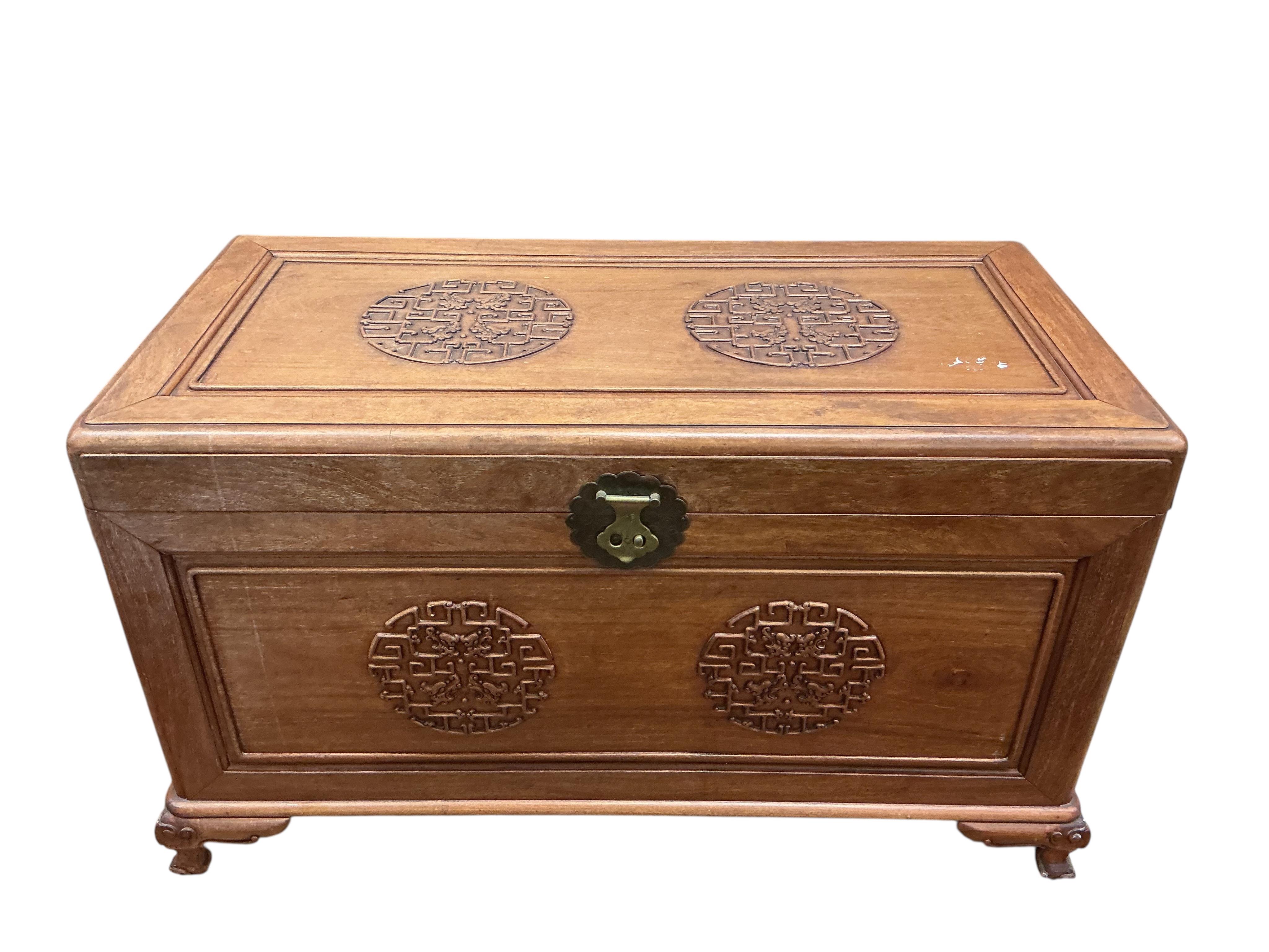 A Chinese carved camphor wood trunk, width 100cm, depth 54cm, height 59cm